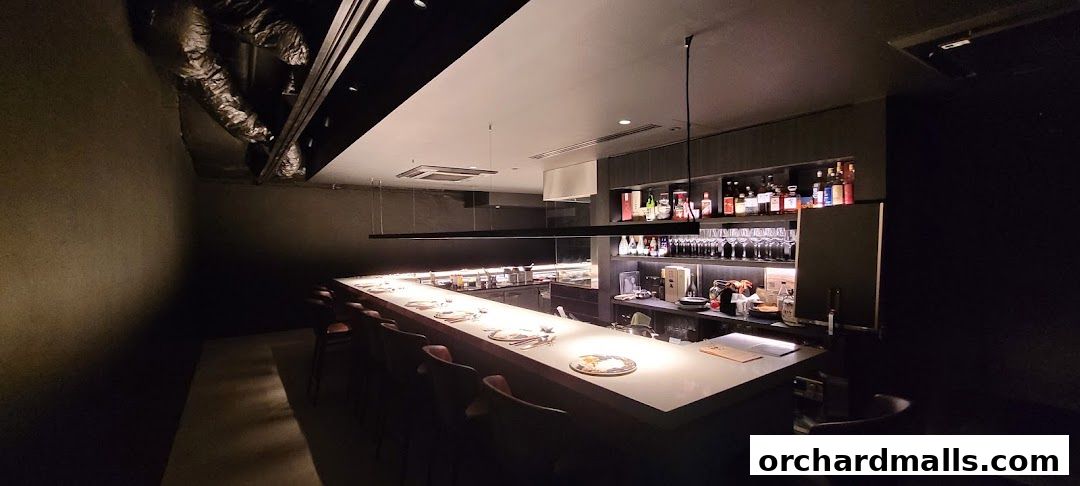 Interior of a modern Chinese restaurant with a long bar and seating.