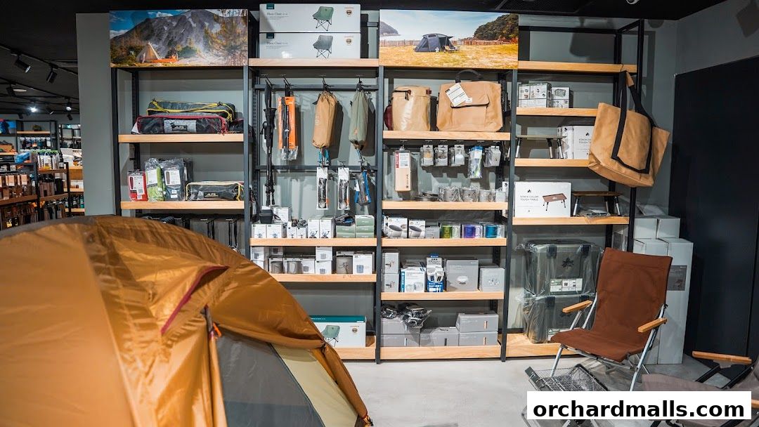 Interior of an outdoor gear shop showcasing tents, chairs, bags, and camping equipment.