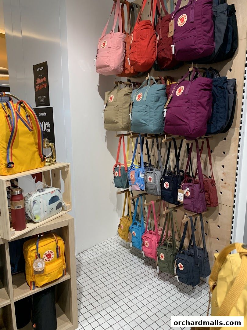 A display of colorful backpacks and bags in various sizes and styles.