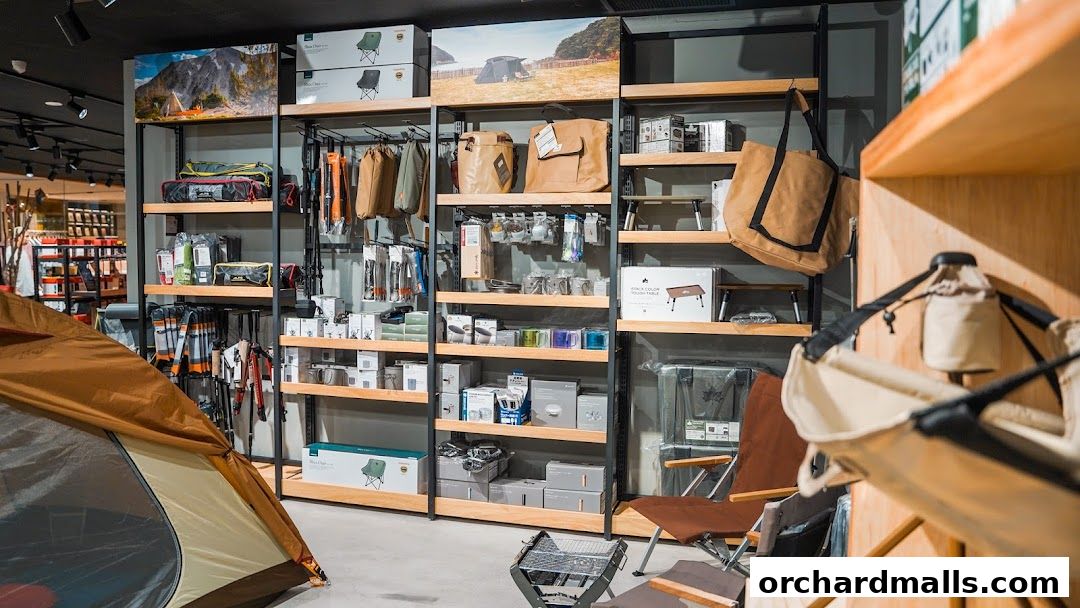 Interior view of an outdoor gear shop showcasing tents, chairs, bags, and camping equipment.