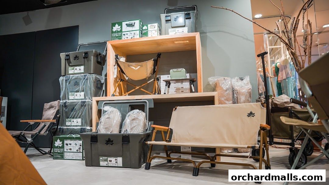 Outdoor gear display featuring camping chairs, storage boxes, and a wagon.
