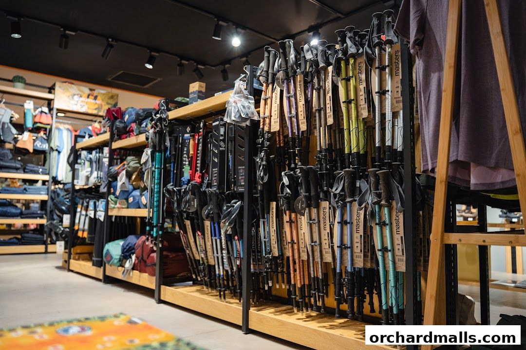 Interior view of an outdoor shop displaying hiking poles and apparel.