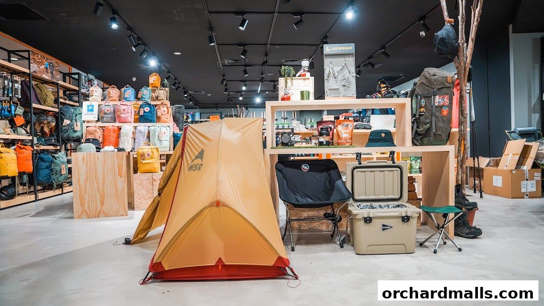 Interior of an outdoor gear shop showcasing tents, backpacks, coolers, and camping chairs.