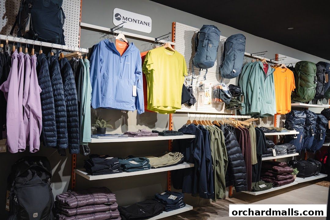 Interior view of an outdoor gear shop displaying jackets, backpacks, and apparel.
