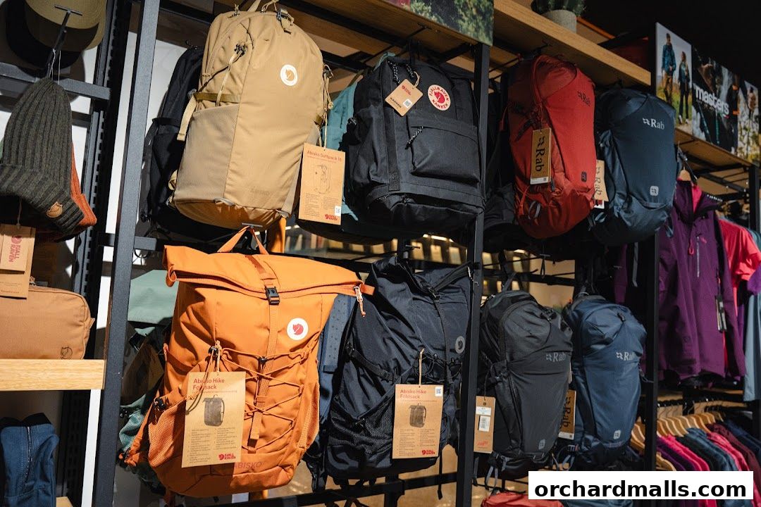 Display of various backpacks, beanies, and outdoor apparel in a retail store.