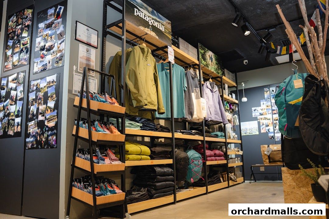 Interior view of an outdoor gear shop with clothing and accessories displayed on shelves.