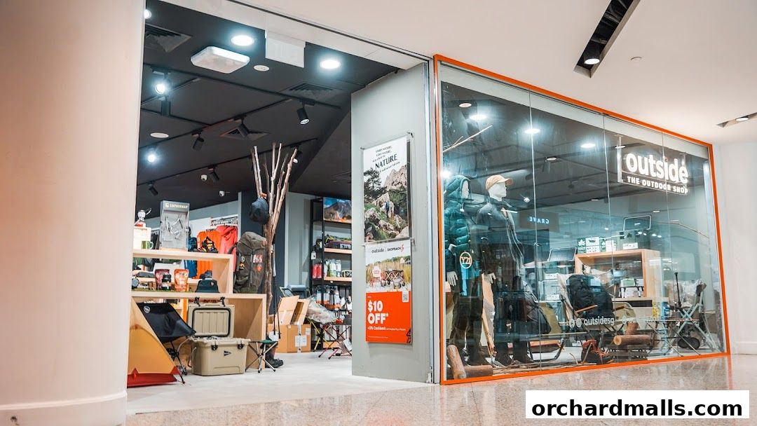 Exterior view of 'Outside The Outdoor Shop' showcasing camping gear and apparel.