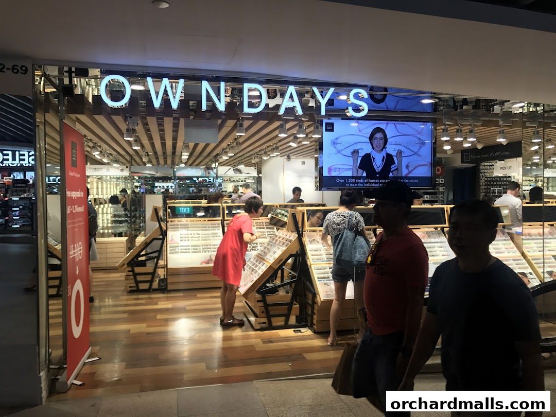 The entrance of OWNDAYS ION Orchard, an eyewear store, with customers browsing.