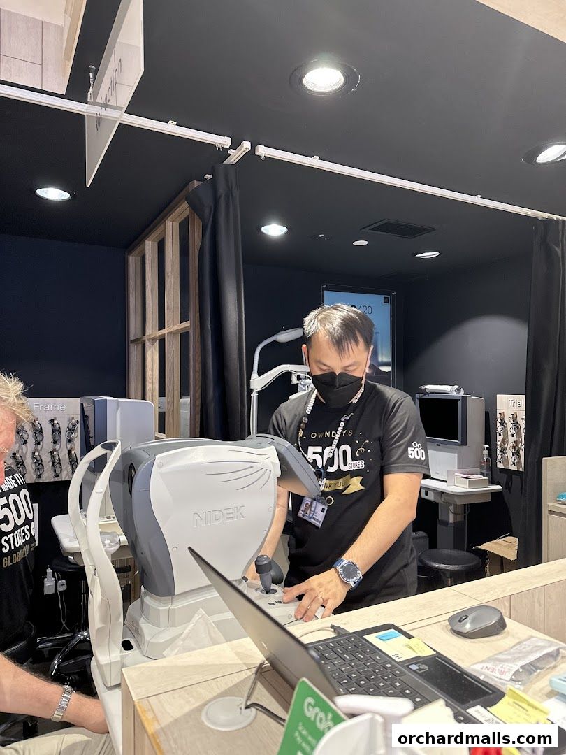 Staff operating an eye examination machine at OWNDAYS ION Orchard.