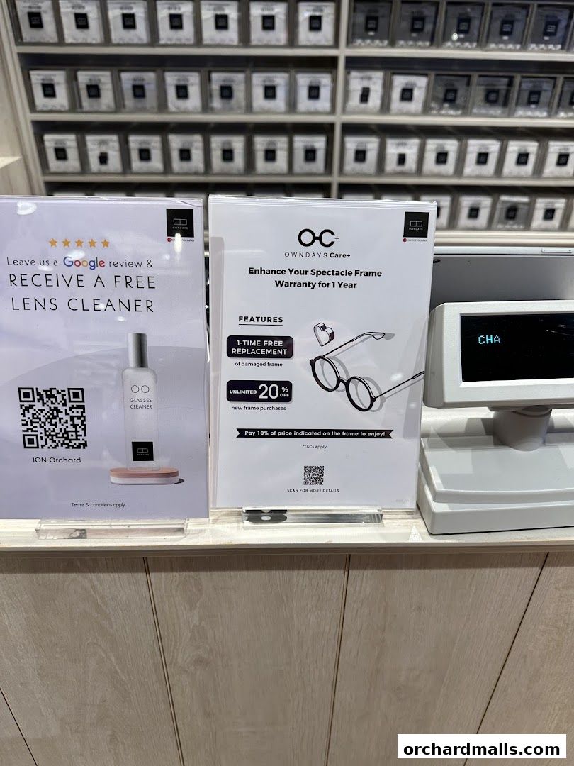 Promotional signs for a free lens cleaner and spectacle frame warranty at OWNDAYS.