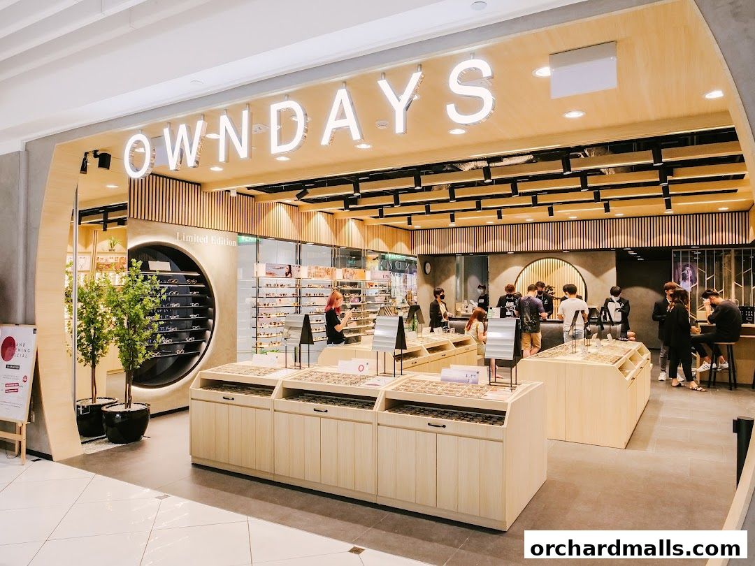 The OWNDAYS optical shop features a modern interior with displays of eyeglasses and customers browsing.