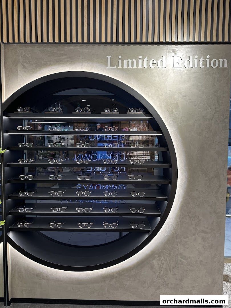 A display of various eyeglasses on shelves within a circular frame, with 'Limited Edition' text above.