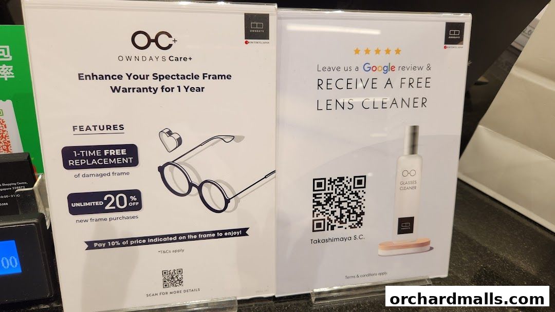 Promotional signs for OWNDAYS offering frame warranty and a free lens cleaner with Google review.
