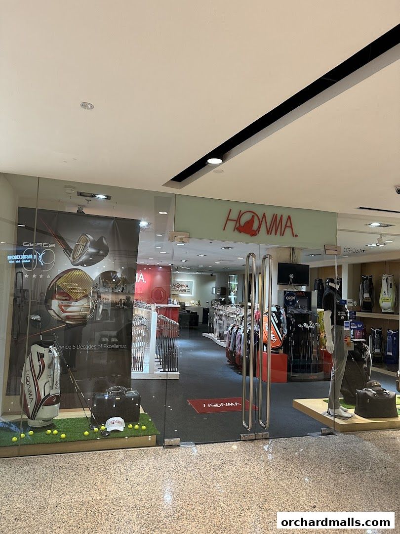 The entrance of a Pan-West Honma golf shop displaying golf bags and clubs.