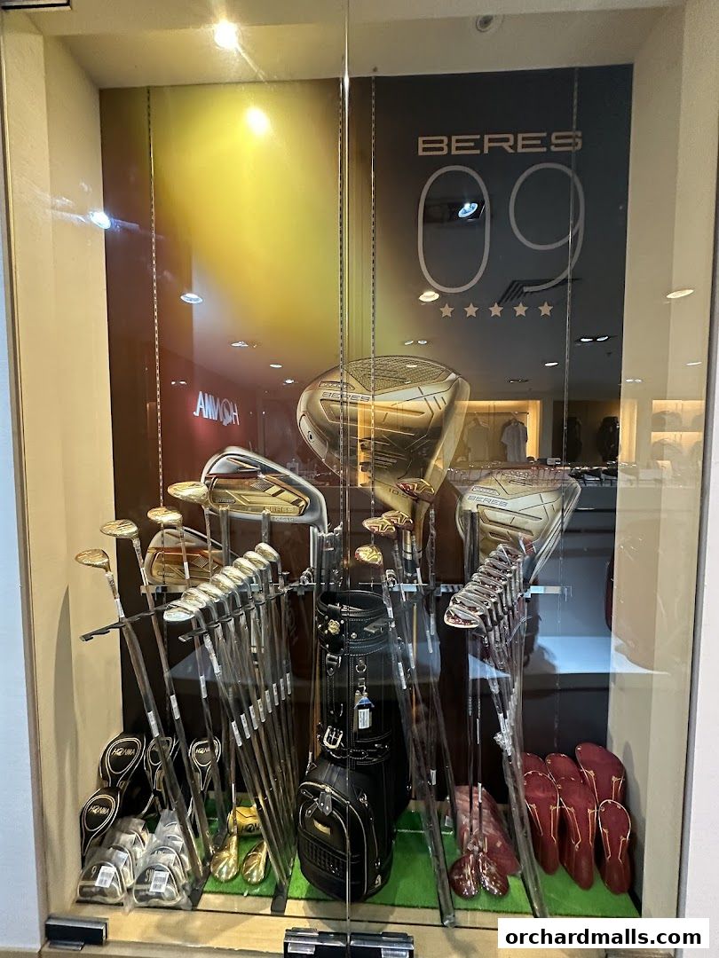 A display window showcasing premium golf clubs, bags, and accessories from Pan-West Honma.