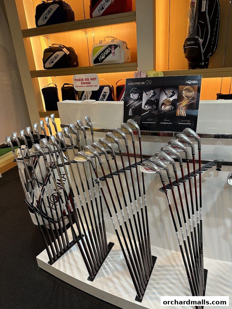 A display of Honma golf clubs and bags in a retail store.