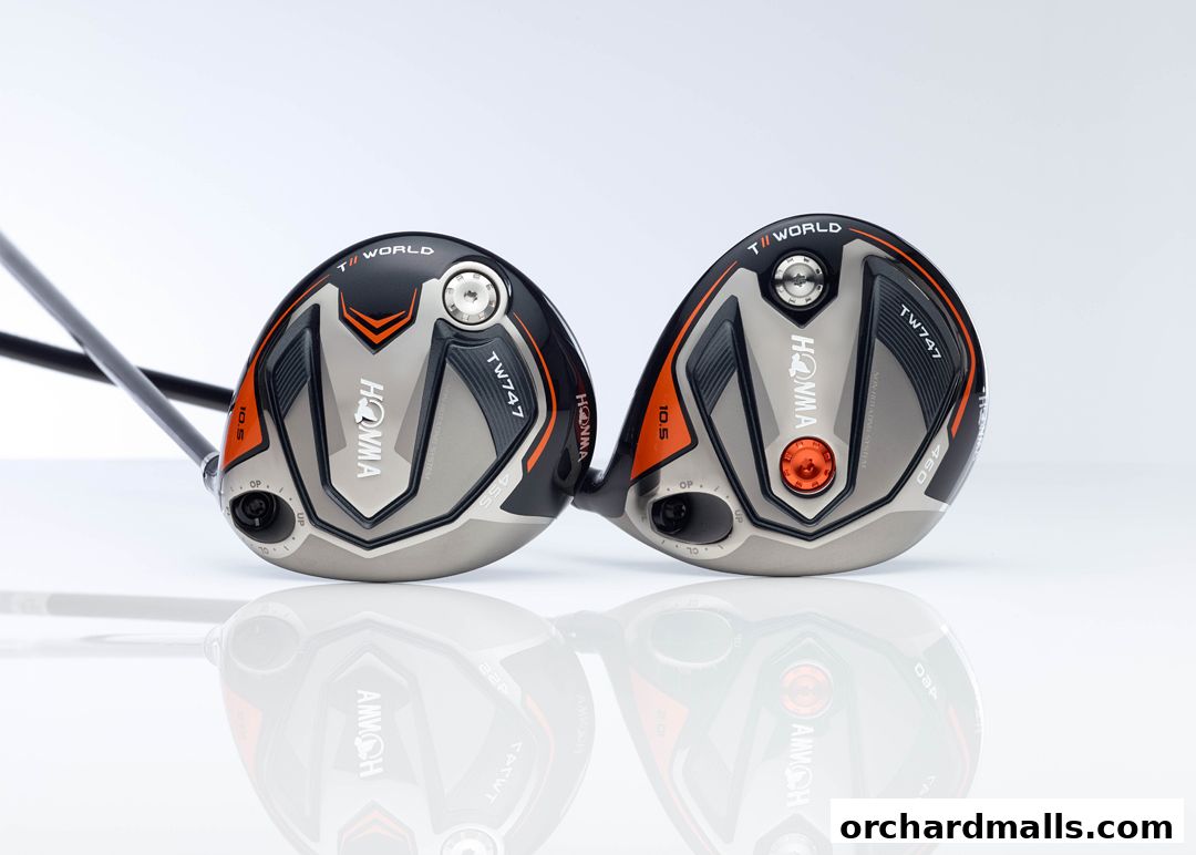 Two Honma TW747 golf drivers with orange and black accents, displayed on a reflective surface.
