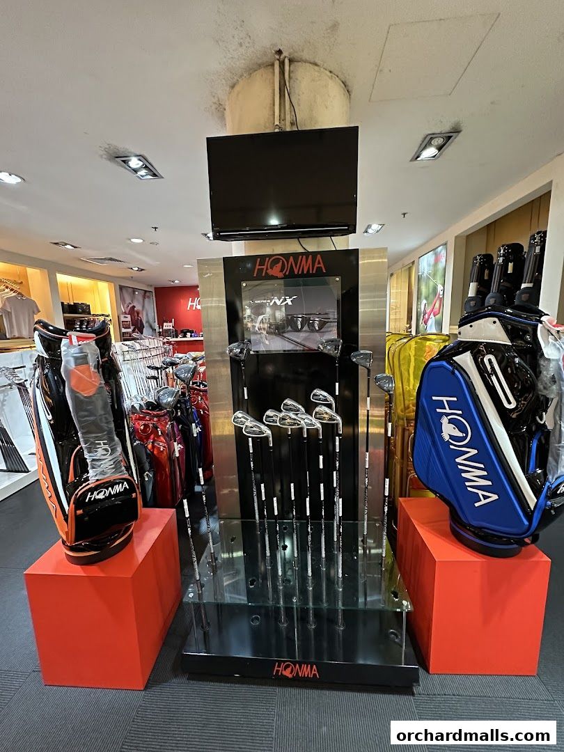 Display of Honma golf clubs and bags inside a retail store.