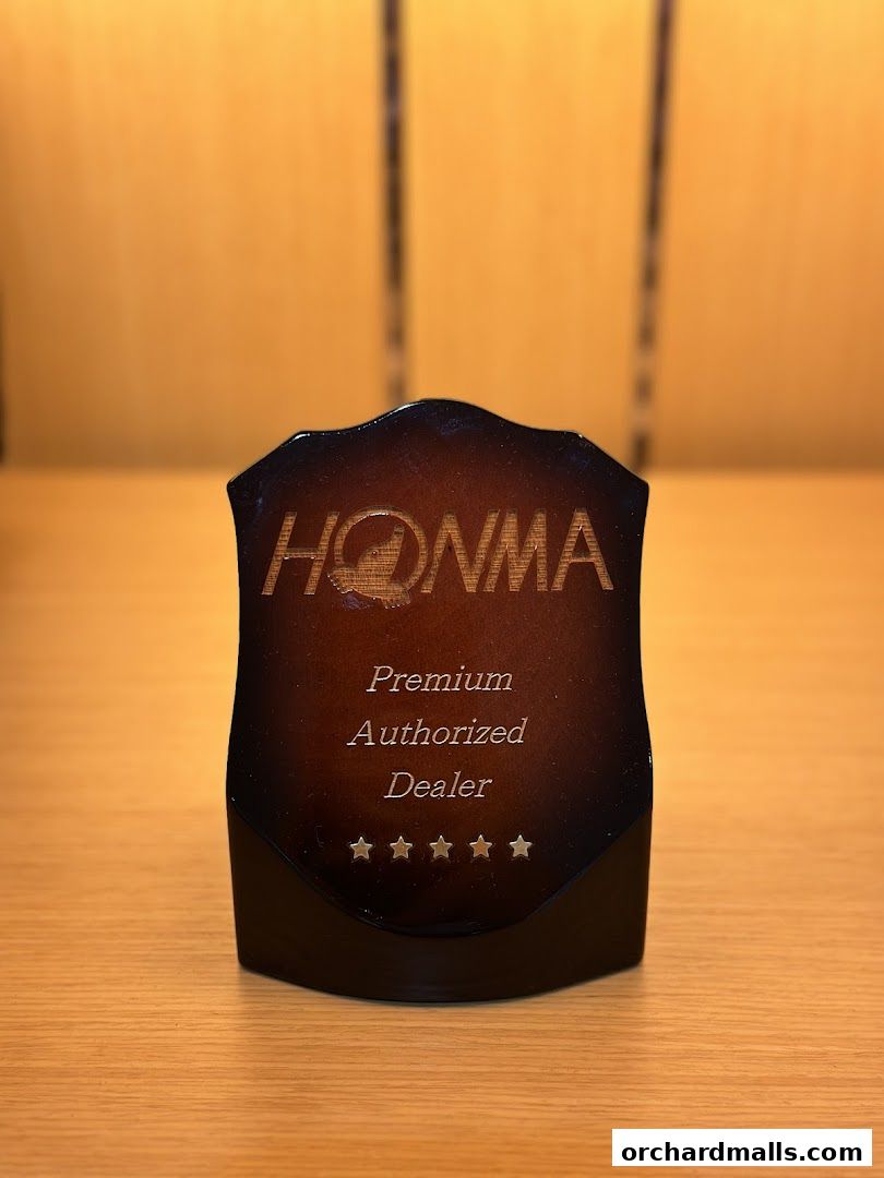 A plaque for Pan-West Honma, a premium authorized dealer, with five stars.