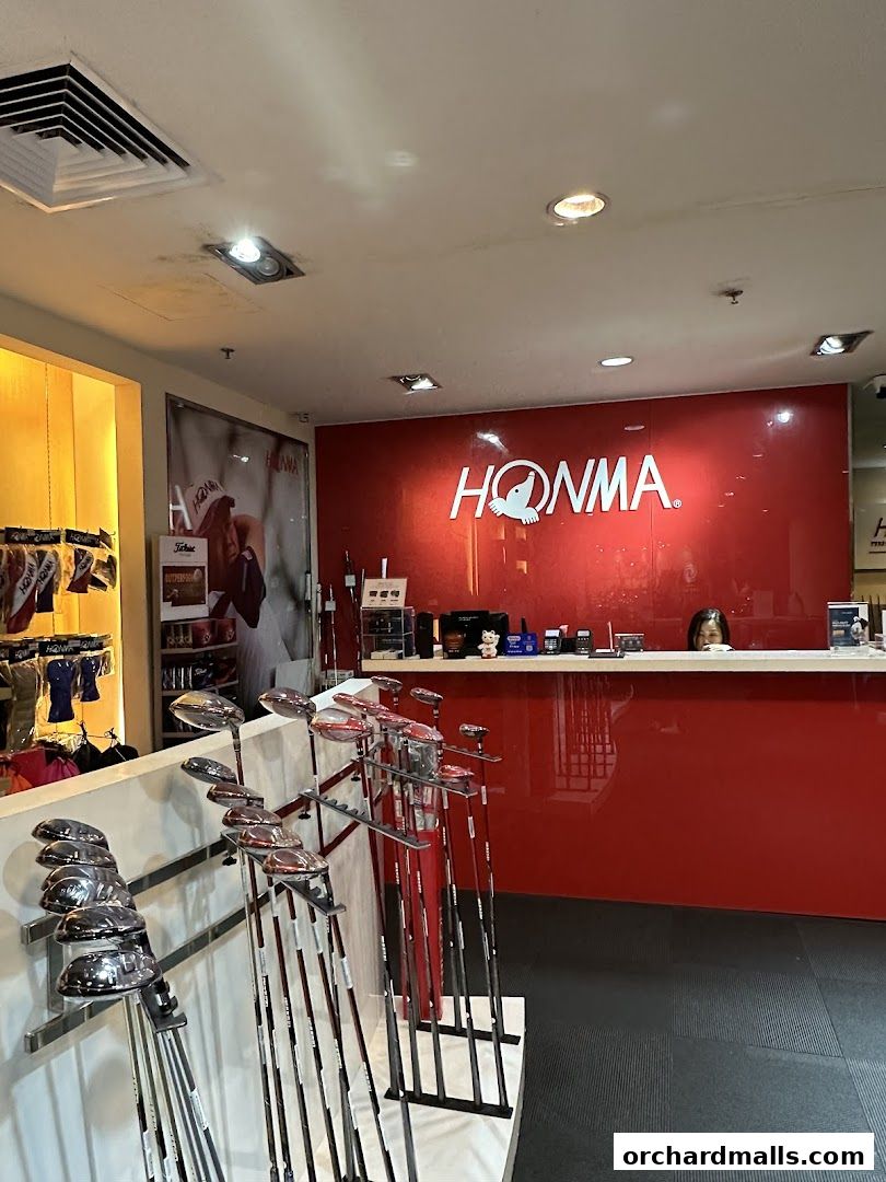 Interior of a golf shop displaying golf clubs and a prominent HONMA logo.