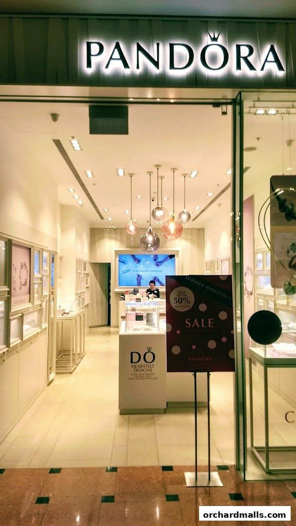 The entrance to a Pandora jewelry store with a sale sign.
