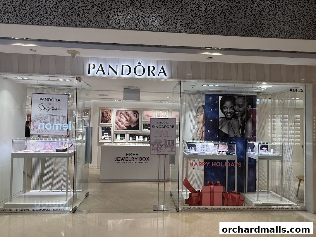 The exterior of a Pandora jewelry store with displays of jewelry and holiday decorations.