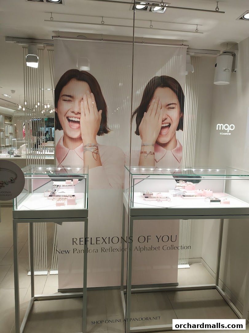 Pandora store window display featuring the 'Reflexions of You' Alphabet Collection.