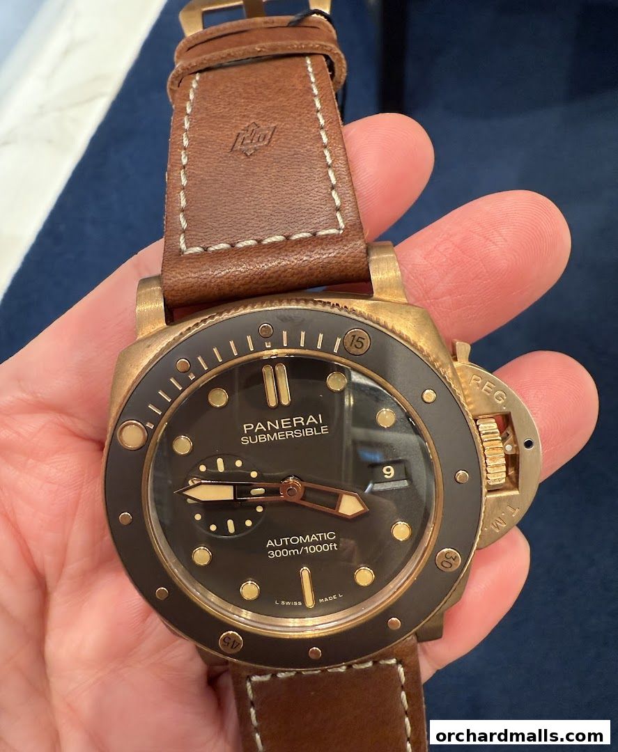 A close-up shot of a Panerai Submersible watch with a brown leather strap.