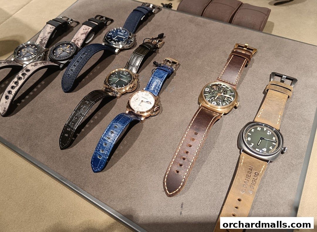 A collection of luxury Panerai watches with various strap designs displayed on a grey surface.