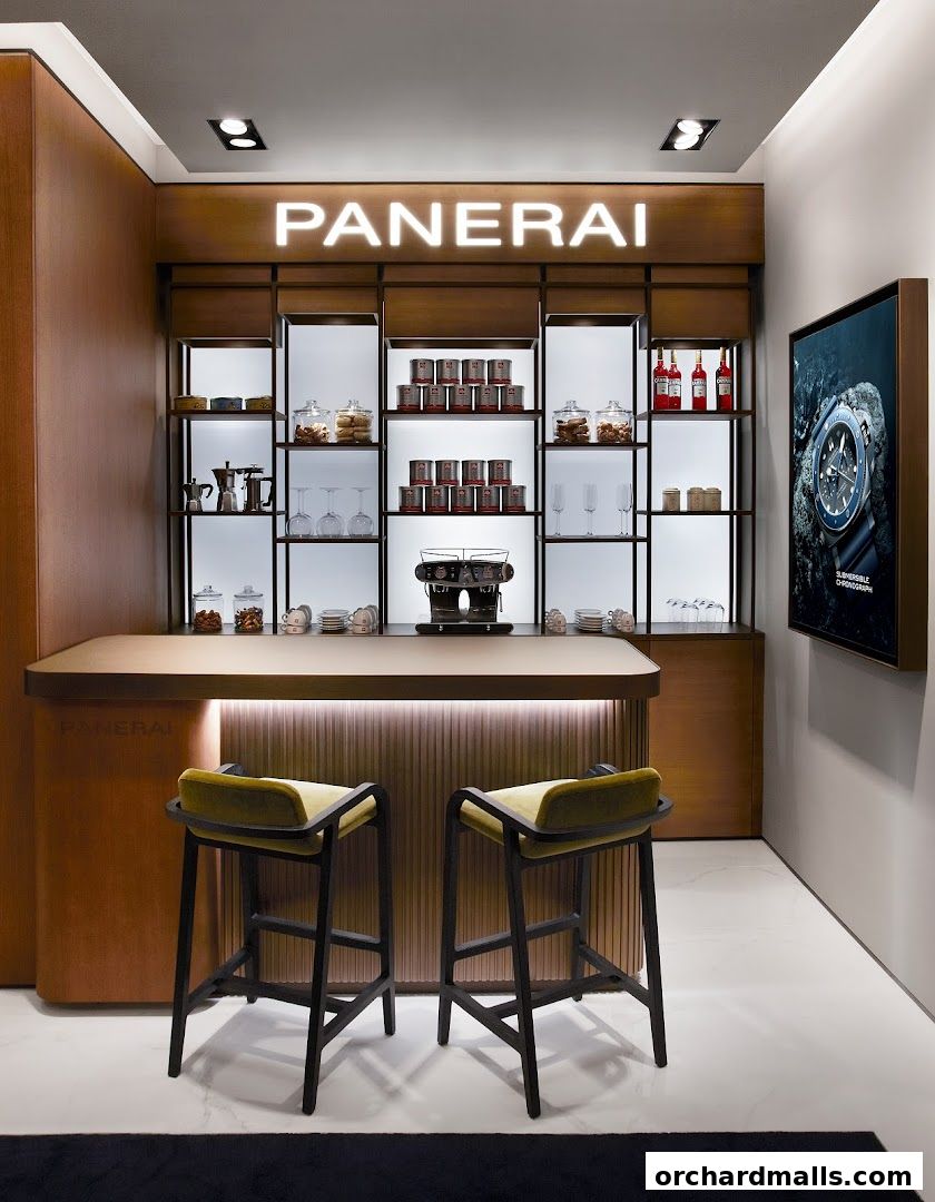 A modern Panerai boutique interior with a bar, seating, and display shelves.