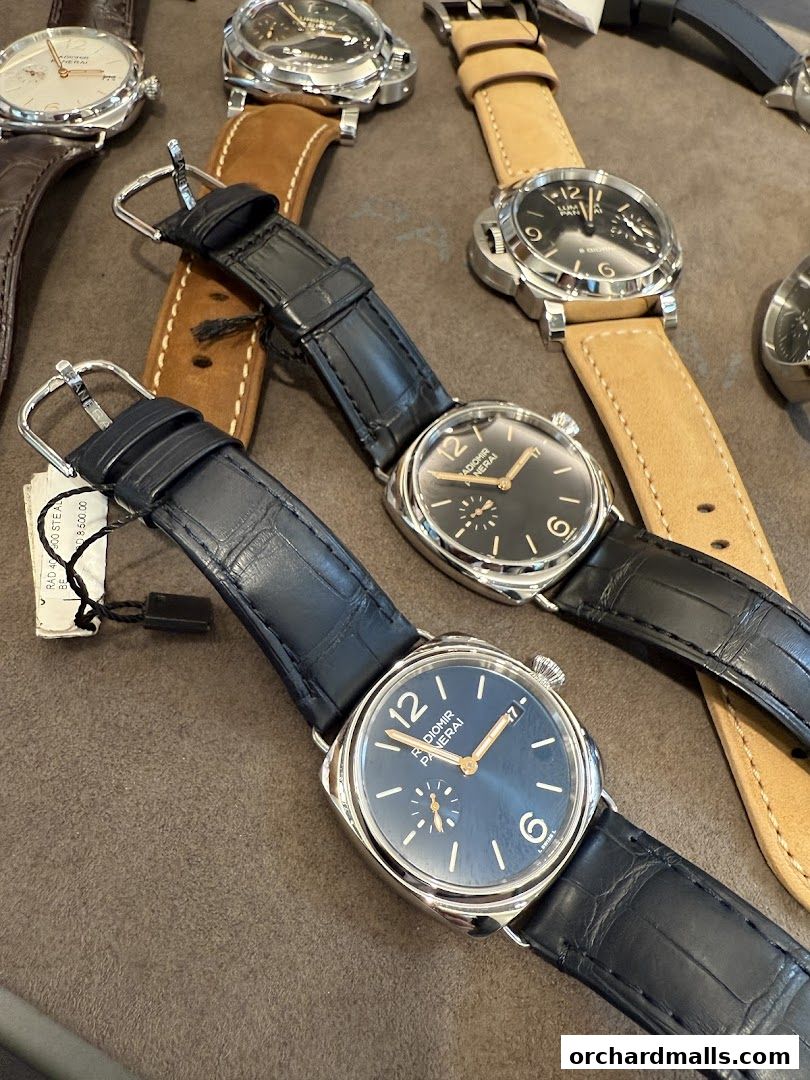 A close-up view of several luxury Panerai watches with leather straps.