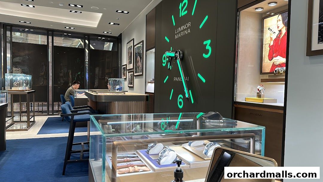 Interior of a luxury watch boutique with display cases and a large wall clock.