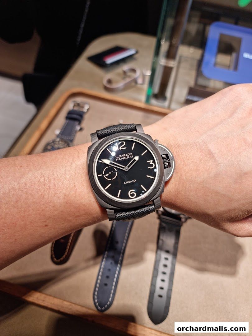 A close-up shot of a Panerai Luminor LAB-ID watch on a wrist, with other watch straps visible.