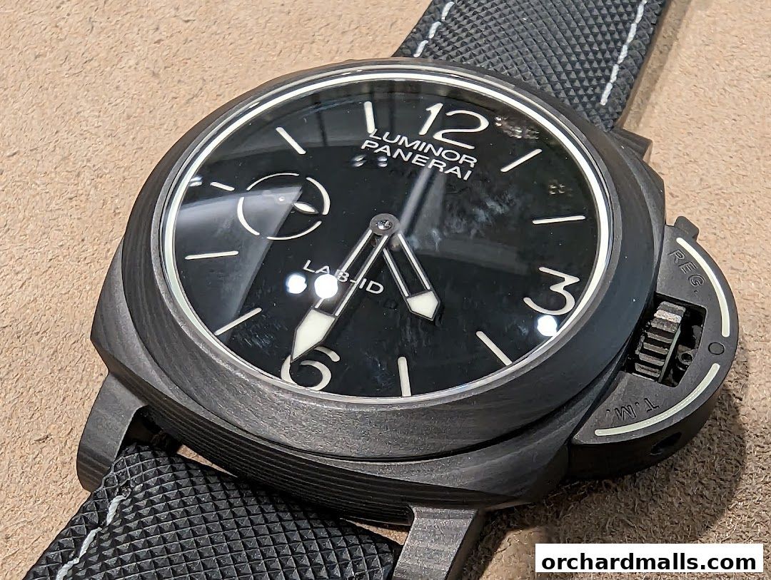 Close-up of a black Panerai Luminor watch with a textured strap.