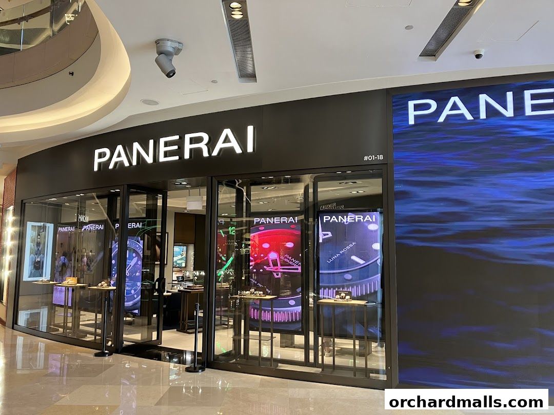 The exterior of a Panerai Boutique with illuminated signage and display windows showcasing watches.
