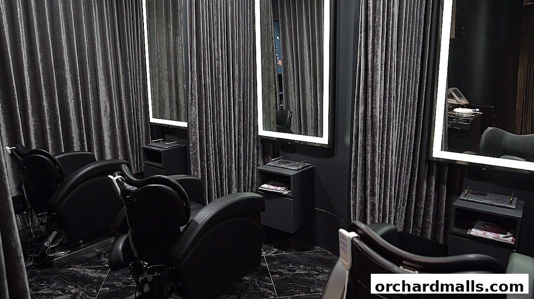 Luxurious salon interior with comfortable chairs and illuminated mirrors.