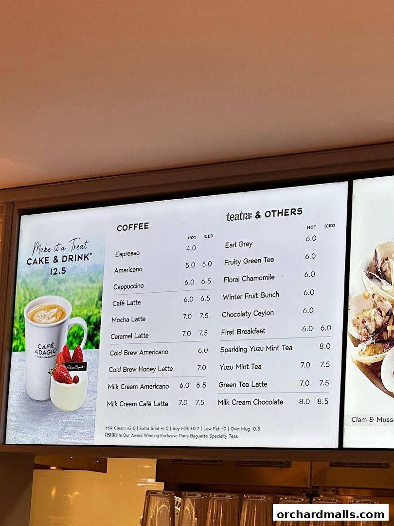 A menu board displaying coffee and tea options with prices, alongside a promotional image.