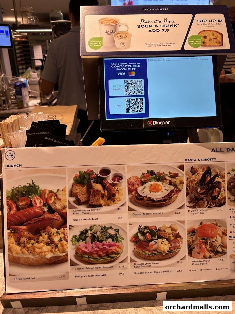 A menu display at Paris Baguette featuring brunch, pasta, and risotto dishes with prices.