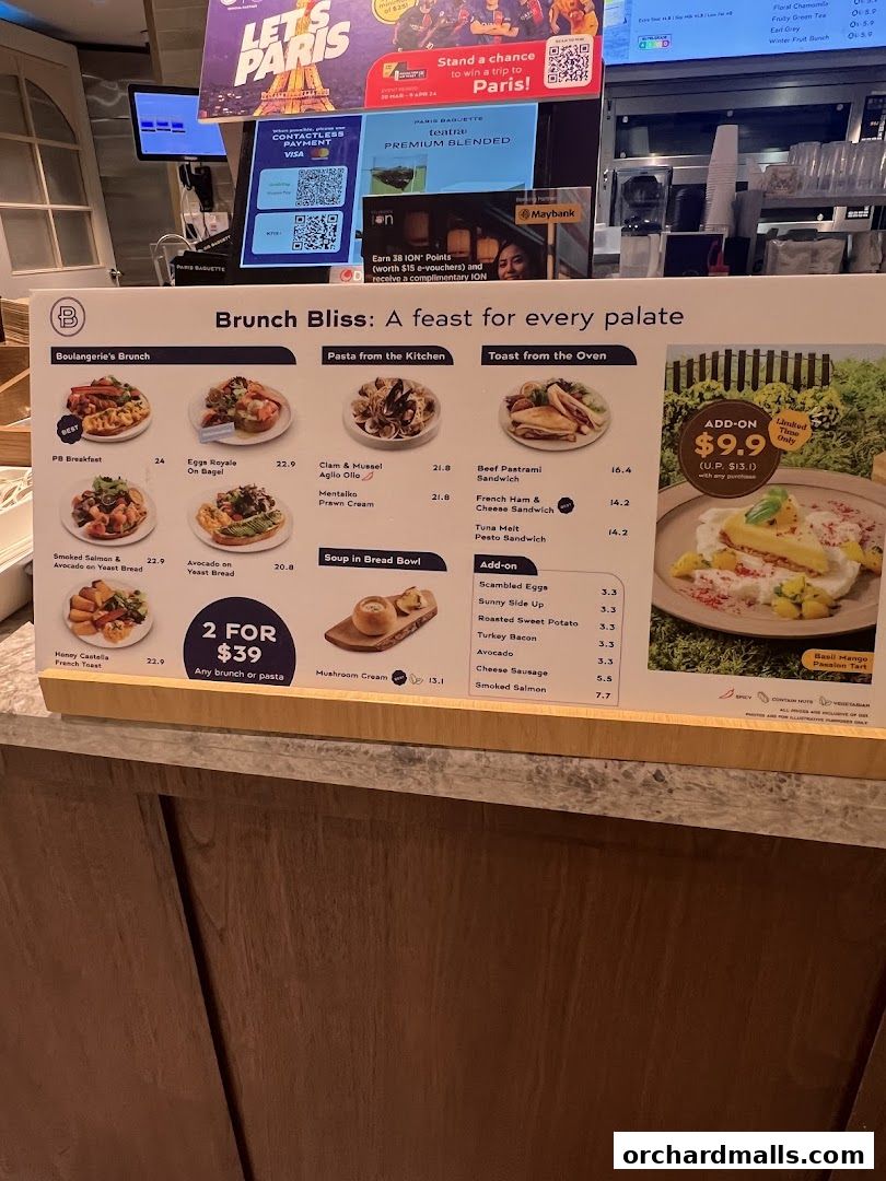 A menu board displaying various brunch items, pasta, toast, and add-ons with prices.