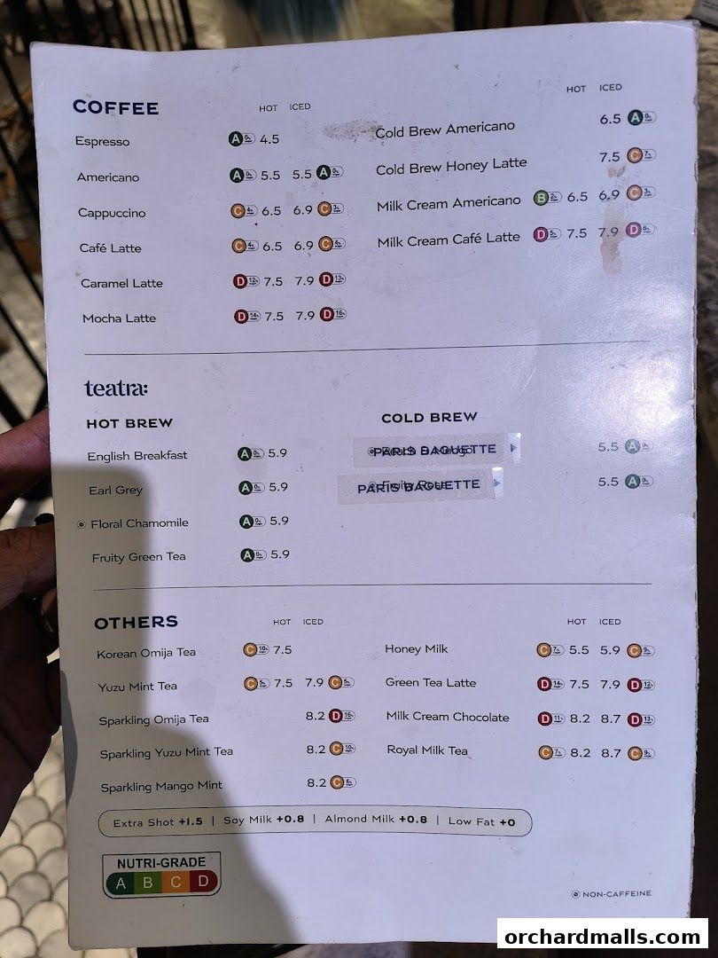 A menu from Paris Baguette featuring coffee, tea, and other beverages with prices and nutritional grades.