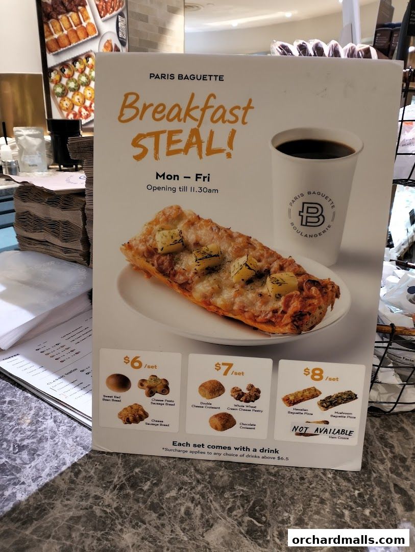 A Paris Baguette sign advertising a breakfast deal with various pastry sets and a drink.