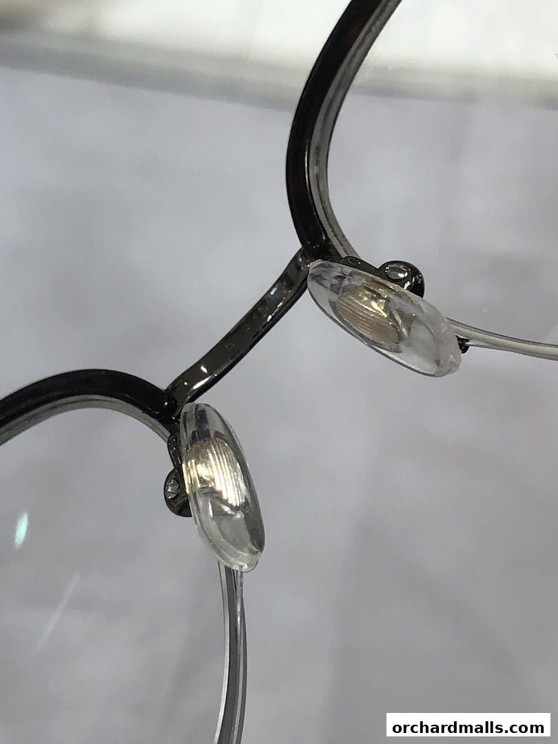 Close-up of the nose pads and frame of a pair of eyeglasses.