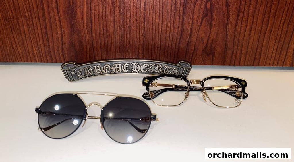 Chrome Hearts branded sunglasses and eyeglasses displayed with a decorative metal piece.