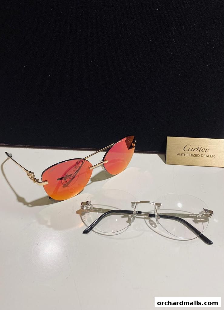 Two pairs of stylish eyeglasses, one with orange lenses and gold frames, and another clear lens pair.