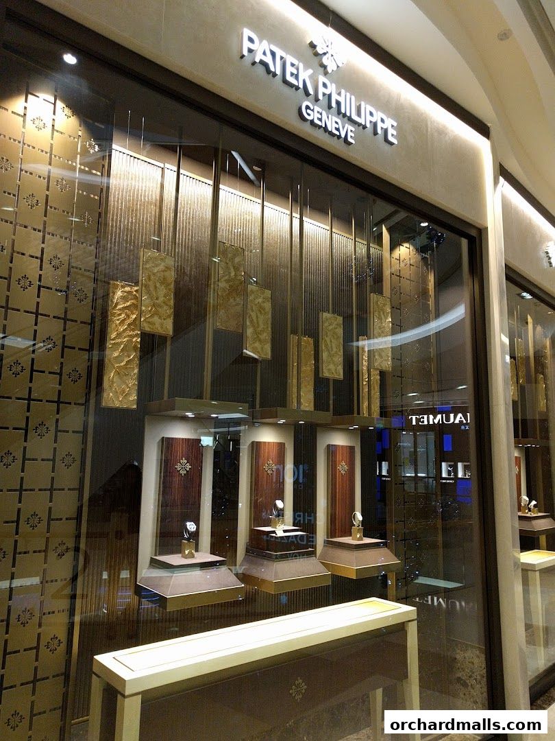 The elegant storefront of a Patek Philippe boutique, showcasing luxury watches in a well-lit display.