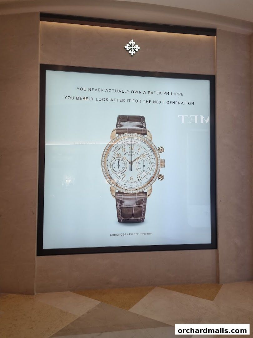 A Patek Philippe advertisement featuring a luxury chronograph watch with a diamond-studded bezel.