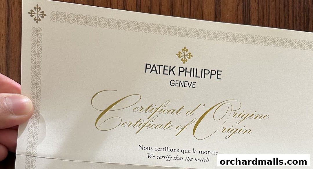 A Patek Philippe Certificate of Origin document with embossed gold lettering.