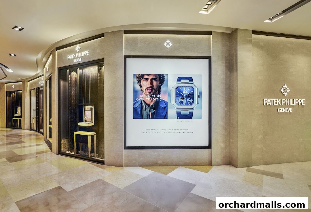 The elegant interior of a Patek Philippe boutique, showcasing watches and advertising.