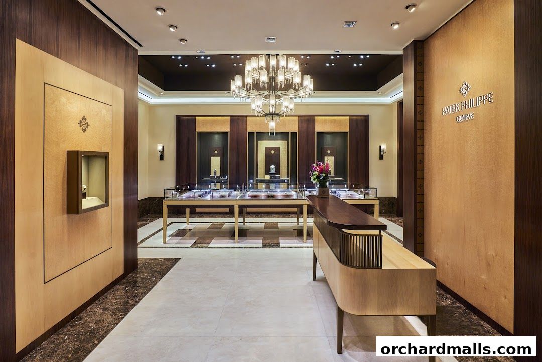 Interior of a luxurious Patek Philippe watch boutique with display cases and a chandelier.