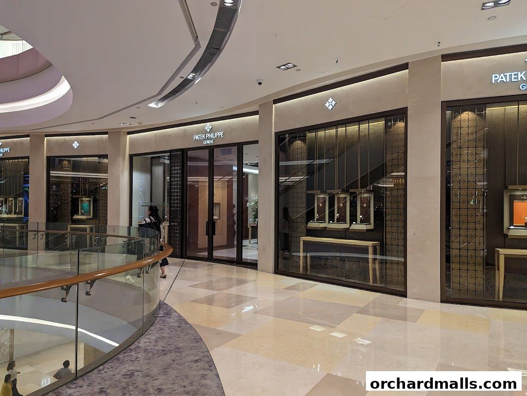 The elegant Patek Philippe boutique entrance with illuminated displays showcasing luxury watches.